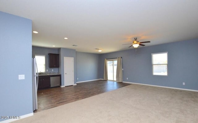 carpeted spare room with a wealth of natural light and ceiling fan