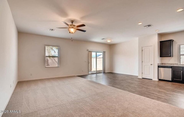 empty room featuring carpet flooring and ceiling fan