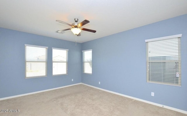 unfurnished room featuring light carpet and ceiling fan