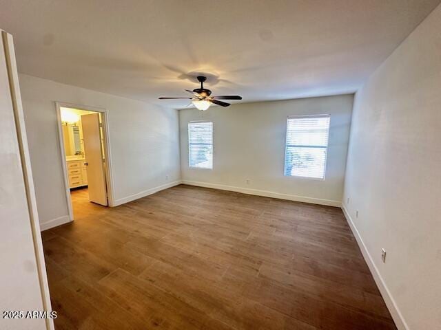 spare room with hardwood / wood-style flooring and ceiling fan