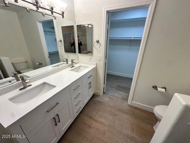 bathroom featuring hardwood / wood-style floors, toilet, and vanity