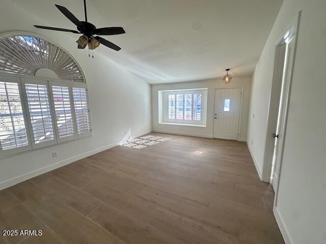 entryway featuring hardwood / wood-style floors, vaulted ceiling, and ceiling fan