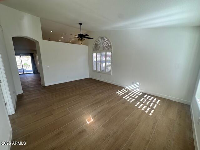 empty room featuring ceiling fan and dark hardwood / wood-style flooring