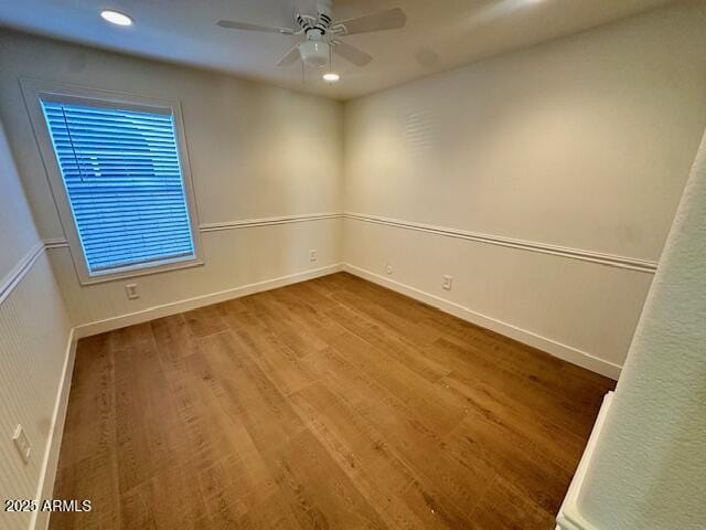 empty room featuring ceiling fan and wood-type flooring