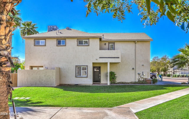 view of front of house featuring a front yard and stucco siding