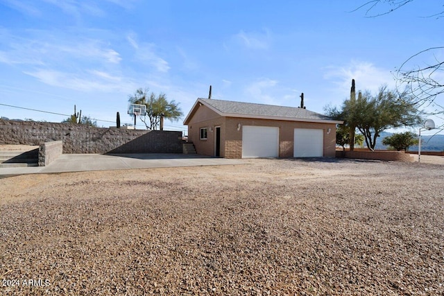 view of home's exterior with a garage and an outdoor structure