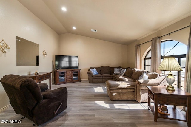 living room featuring light hardwood / wood-style flooring and vaulted ceiling