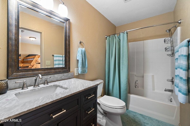 full bathroom featuring shower / tub combo with curtain, vanity, a textured ceiling, and toilet