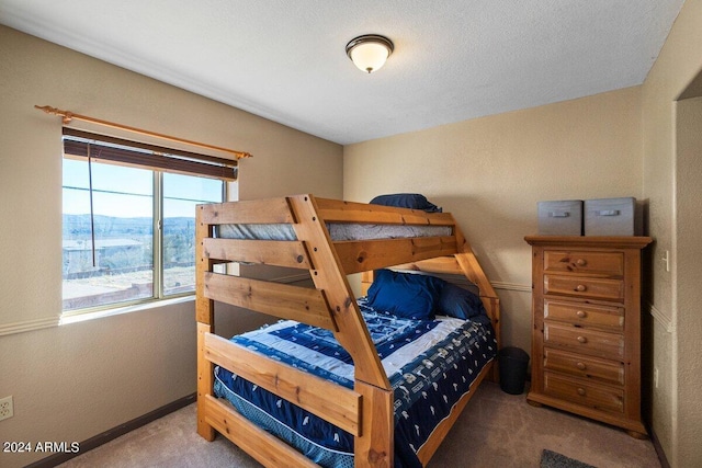 carpeted bedroom featuring a textured ceiling