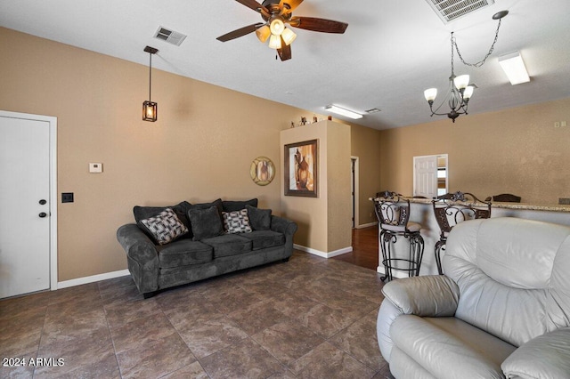 living room with ceiling fan with notable chandelier