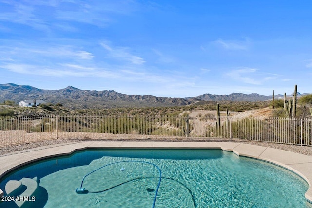 view of swimming pool with a mountain view