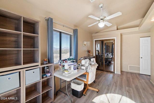 home office with hardwood / wood-style floors, ceiling fan, and lofted ceiling