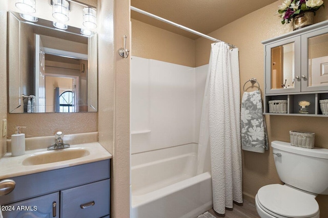 full bathroom with shower / bath combo with shower curtain, vanity, hardwood / wood-style floors, and toilet