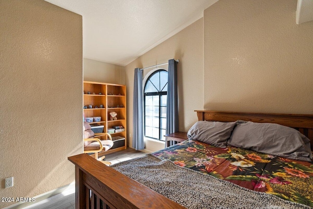 bedroom with light hardwood / wood-style flooring and vaulted ceiling