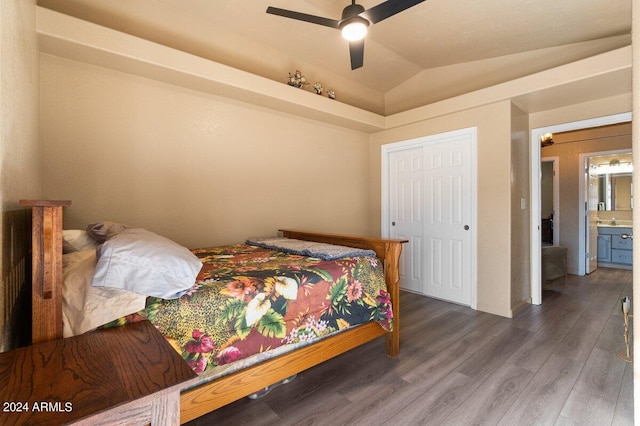 bedroom featuring ensuite bathroom, vaulted ceiling, ceiling fan, dark hardwood / wood-style floors, and a closet