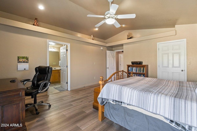 bedroom featuring hardwood / wood-style flooring, ensuite bathroom, ceiling fan, and vaulted ceiling