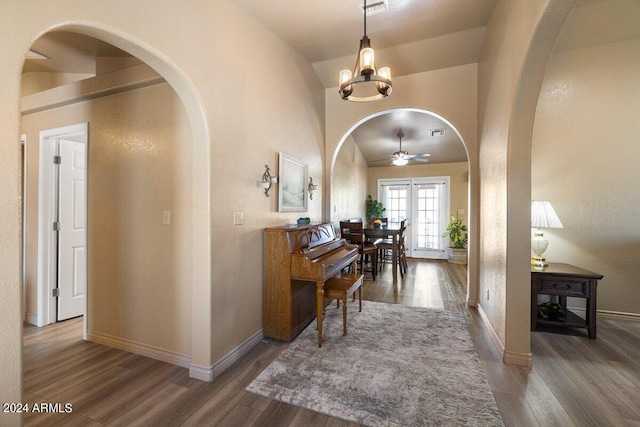 hall featuring a chandelier, hardwood / wood-style floors, vaulted ceiling, and french doors