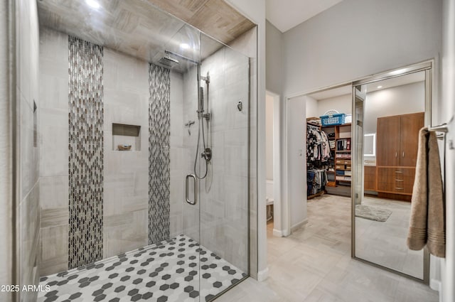 7304 E Bent Tree Dr, Scottsdale, AZ 85266 - bathroom featuring a stall shower, a walk in closet, and baseboards