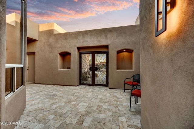 7304 E Bent Tree Dr, Scottsdale, AZ 85266 - view of exterior entry featuring a patio area, stucco siding, and french doors