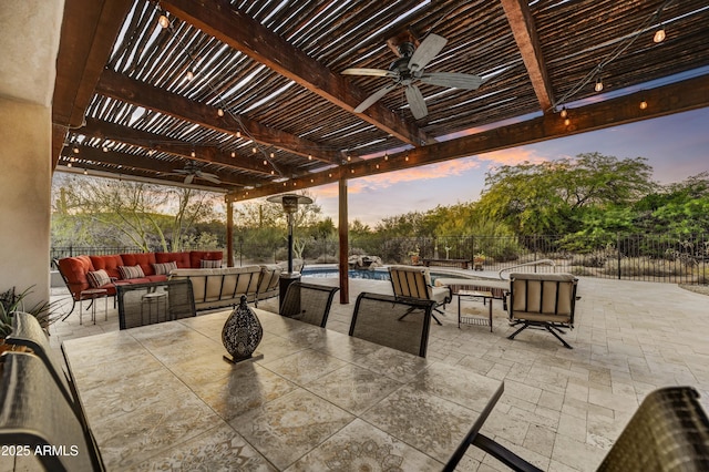 7304 E Bent Tree Dr, Scottsdale, AZ 85266 - patio terrace at dusk featuring ceiling fan, a pergola, outdoor lounge area, a fenced backyard, and a patio area