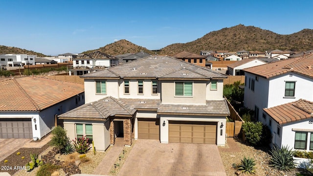 view of front facade with a garage and a mountain view