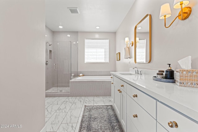 bathroom with vanity and independent shower and bath