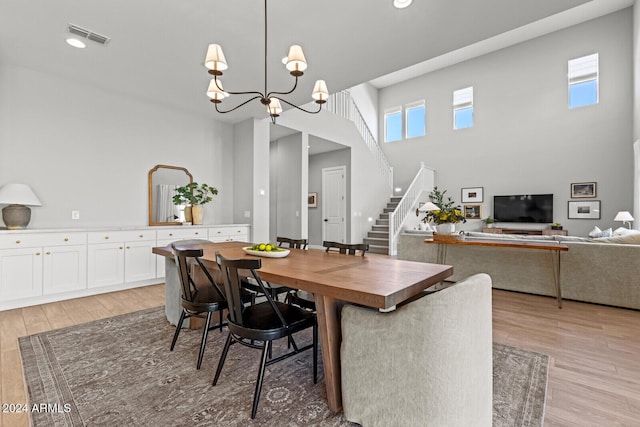 dining area with a chandelier and light hardwood / wood-style floors