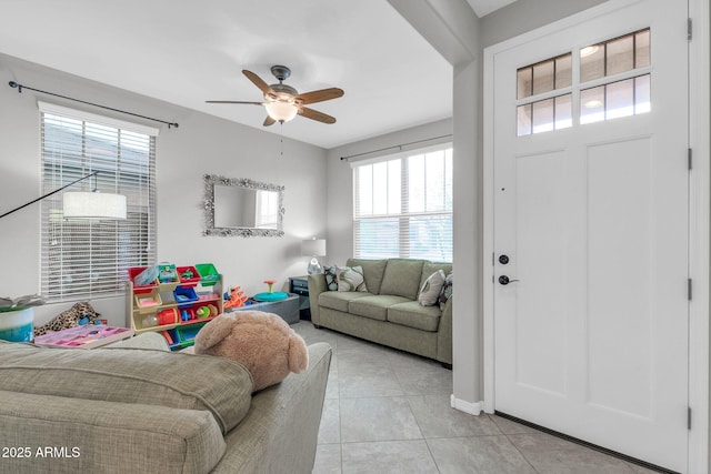 living room featuring ceiling fan and light tile patterned flooring