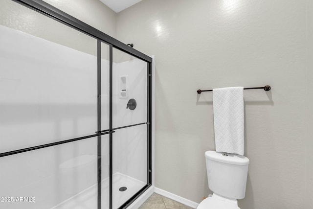 bathroom with walk in shower, tile patterned floors, and toilet