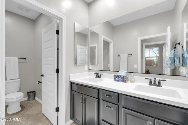 bathroom with tile patterned floors, vanity, and toilet