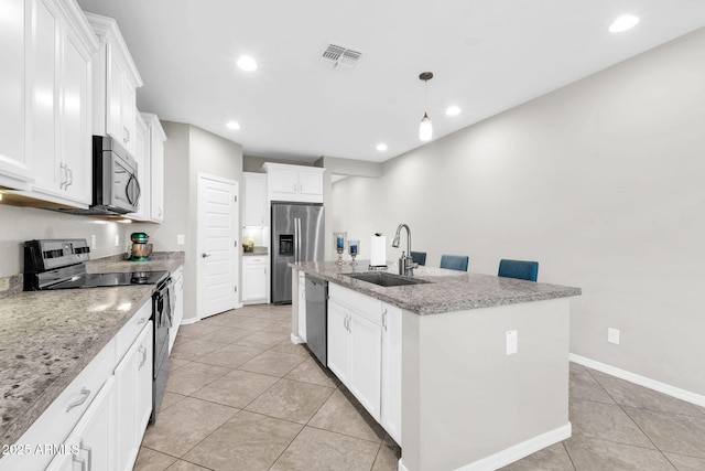 kitchen with stainless steel appliances, sink, a center island with sink, and white cabinets