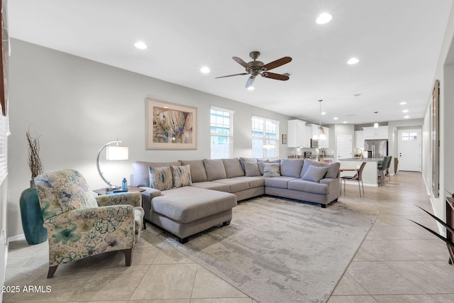 tiled living room with ceiling fan