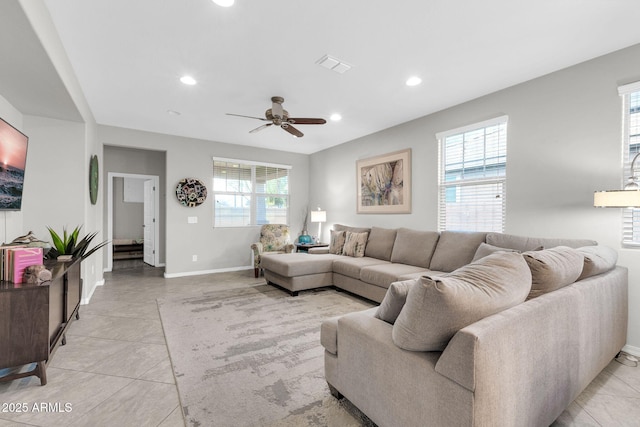 living room with light tile patterned flooring and ceiling fan