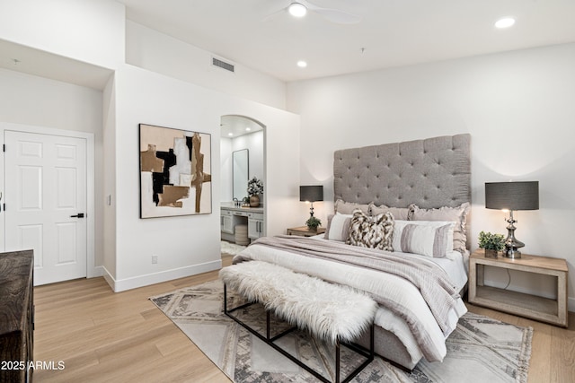 8965 E Maple Dr, Scottsdale, AZ 85255 - bedroom featuring light wood-style flooring, baseboards, recessed lighting, arched walkways, and ensuite bathroom