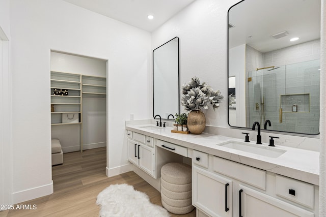 8965 E Maple Dr, Scottsdale, AZ 85255 - full bathroom featuring double vanity, a shower stall, wood finished floors, baseboards, and a spacious closet