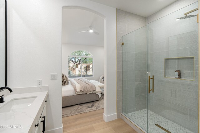 8965 E Maple Dr, Scottsdale, AZ 85255 - ensuite bathroom with wood finished floors, vanity, a shower stall, and ceiling fan