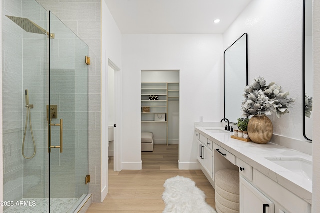 8965 E Maple Dr, Scottsdale, AZ 85255 - bathroom with wood finished floors, a stall shower, double vanity, toilet, and recessed lighting