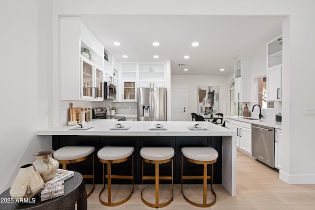 8965 E Maple Dr, Scottsdale, AZ 85255 - kitchen with appliances with stainless steel finishes, a sink, open shelves, a peninsula, and recessed lighting