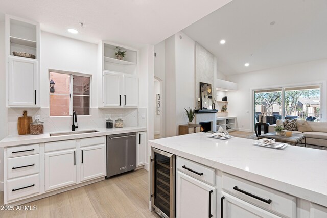 8965 E Maple Dr, Scottsdale, AZ 85255 - kitchen with open shelves, wine cooler, a sink, stainless steel dishwasher, and open floor plan