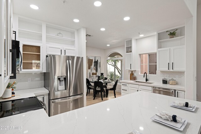 8965 E Maple Dr, Scottsdale, AZ 85255 - kitchen featuring appliances with stainless steel finishes, open shelves, a sink, light stone counters, and recessed lighting