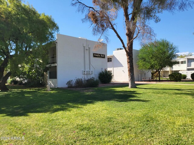 view of side of home featuring a yard