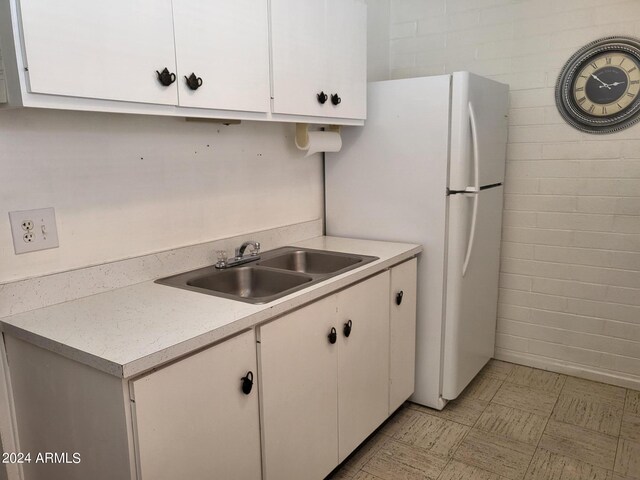 kitchen with sink and white cabinetry