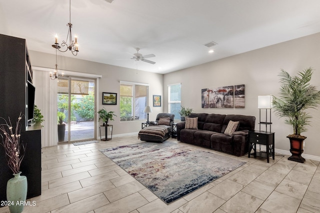 living room featuring ceiling fan with notable chandelier