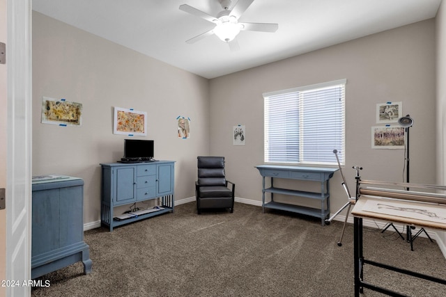 interior space featuring dark carpet and ceiling fan