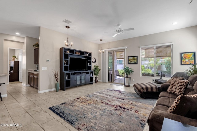 living room with ceiling fan with notable chandelier