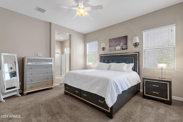 carpeted bedroom featuring ceiling fan and ensuite bathroom