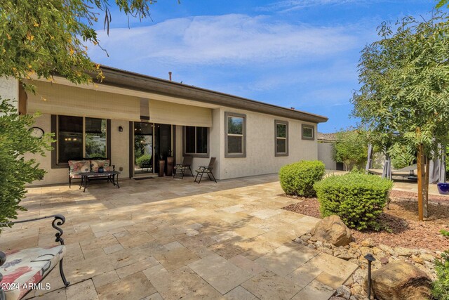 rear view of property with a patio area