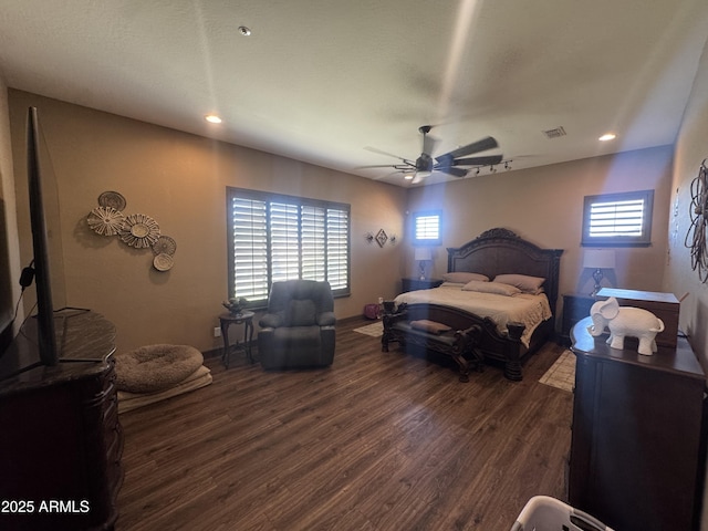 bedroom with ceiling fan, visible vents, wood finished floors, baseboards, and recessed lighting