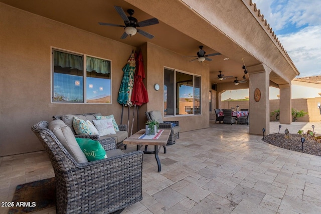 view of patio / terrace featuring fence, ceiling fan, and an outdoor living space