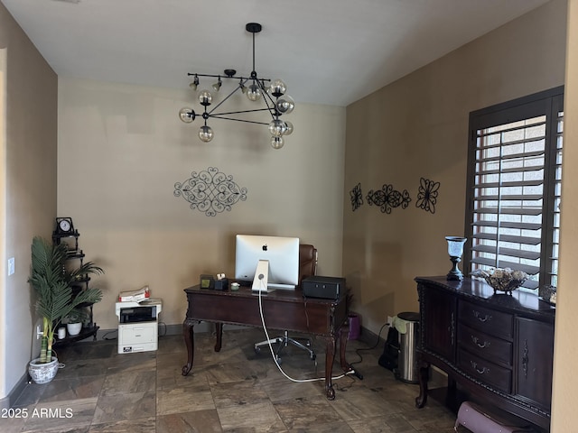 office area with an inviting chandelier, baseboards, and stone finish flooring